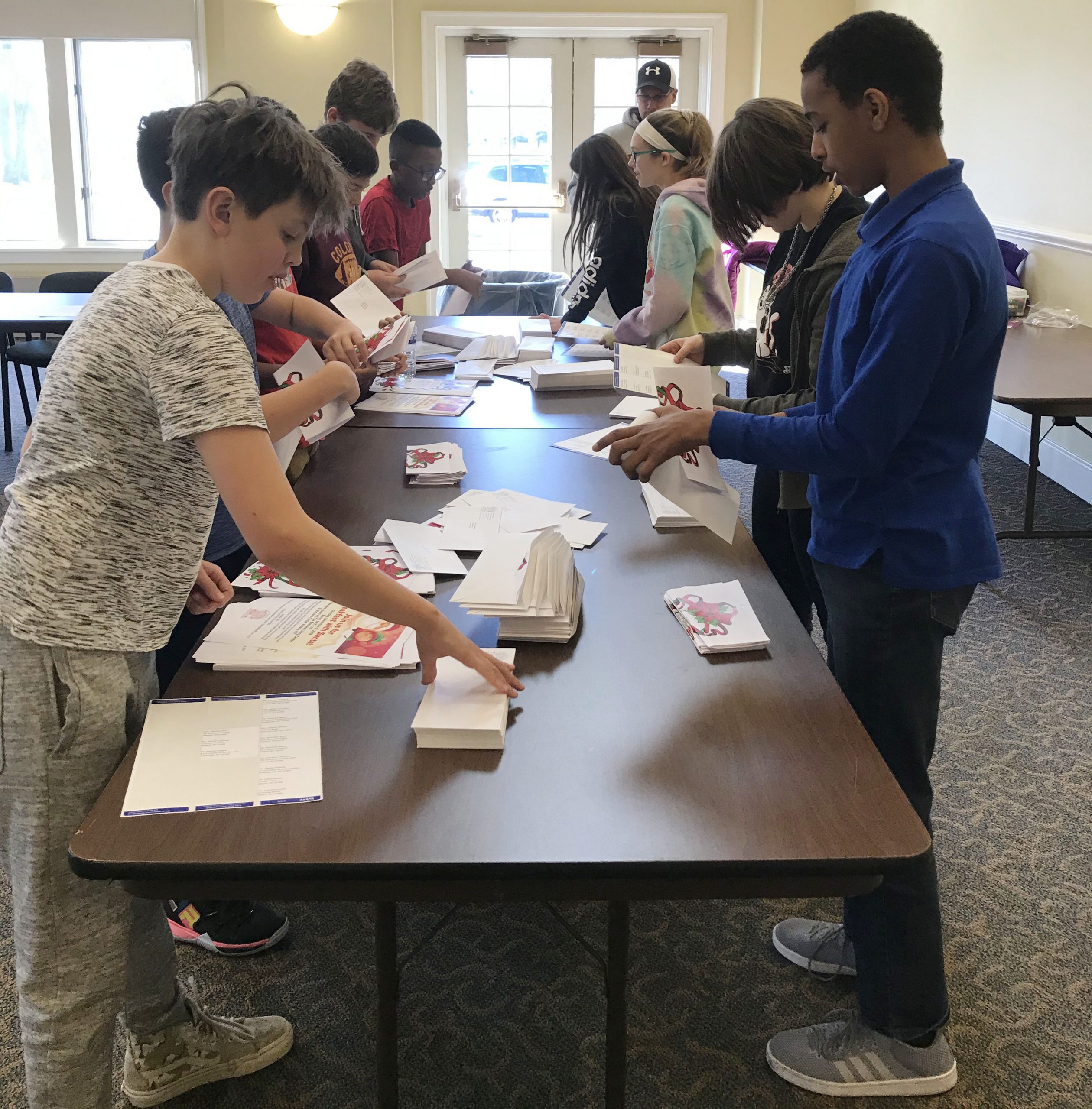 students sort mail at a table