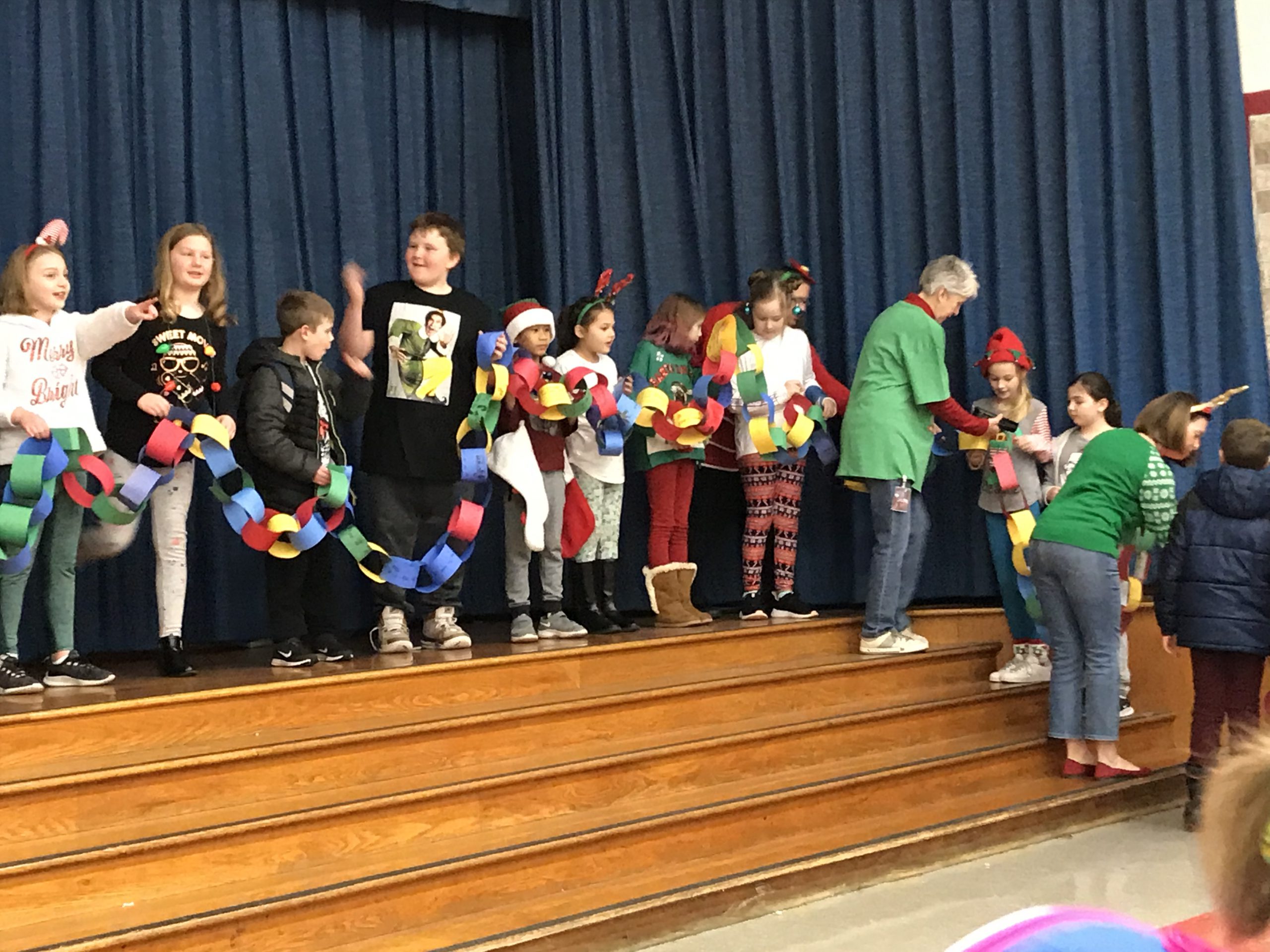 student display long kindness chain on stage