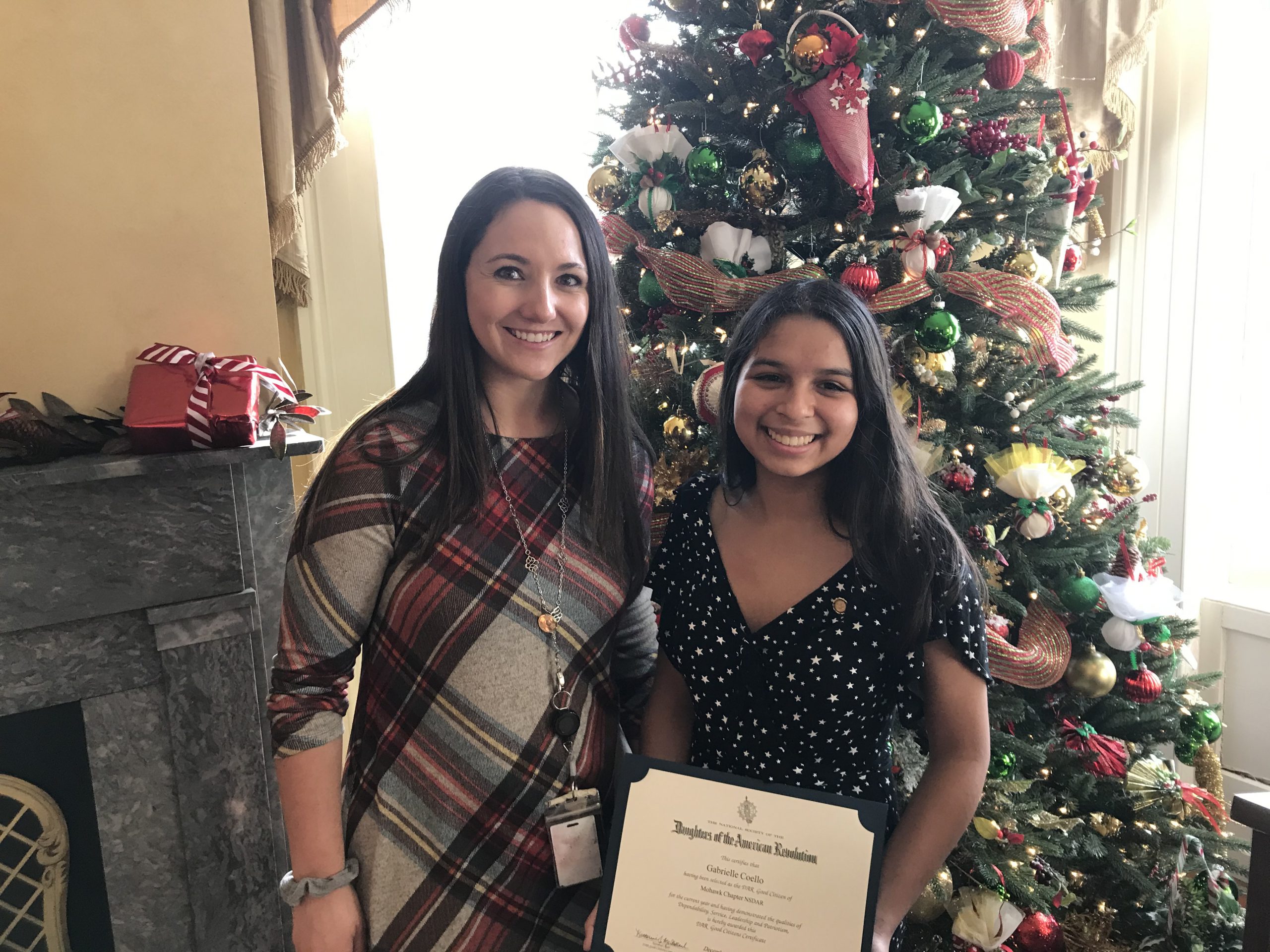 student and her teacher stand together