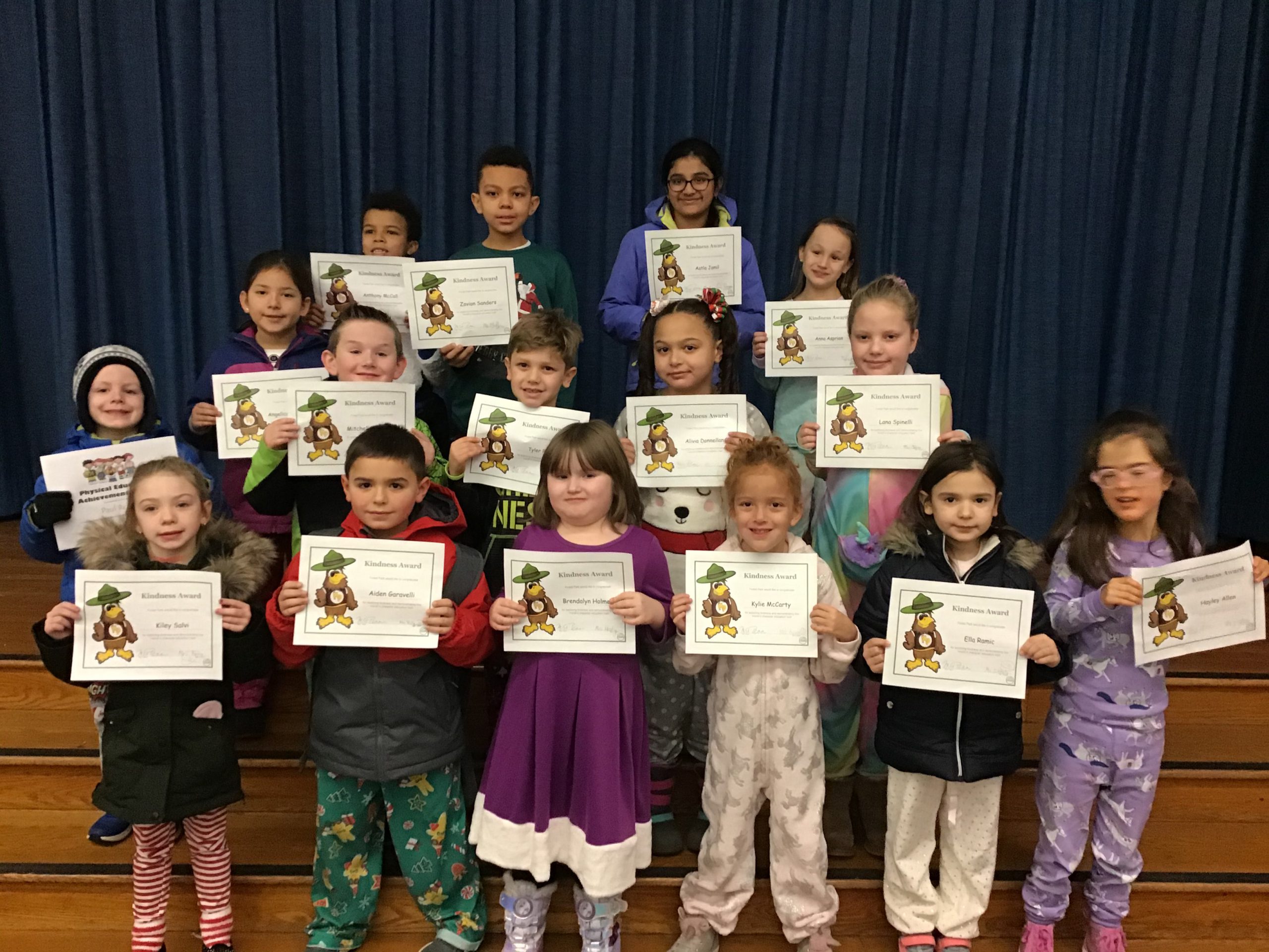 group of students show off their award certificates