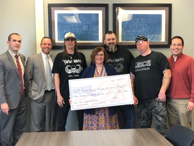 group of musician present a big check