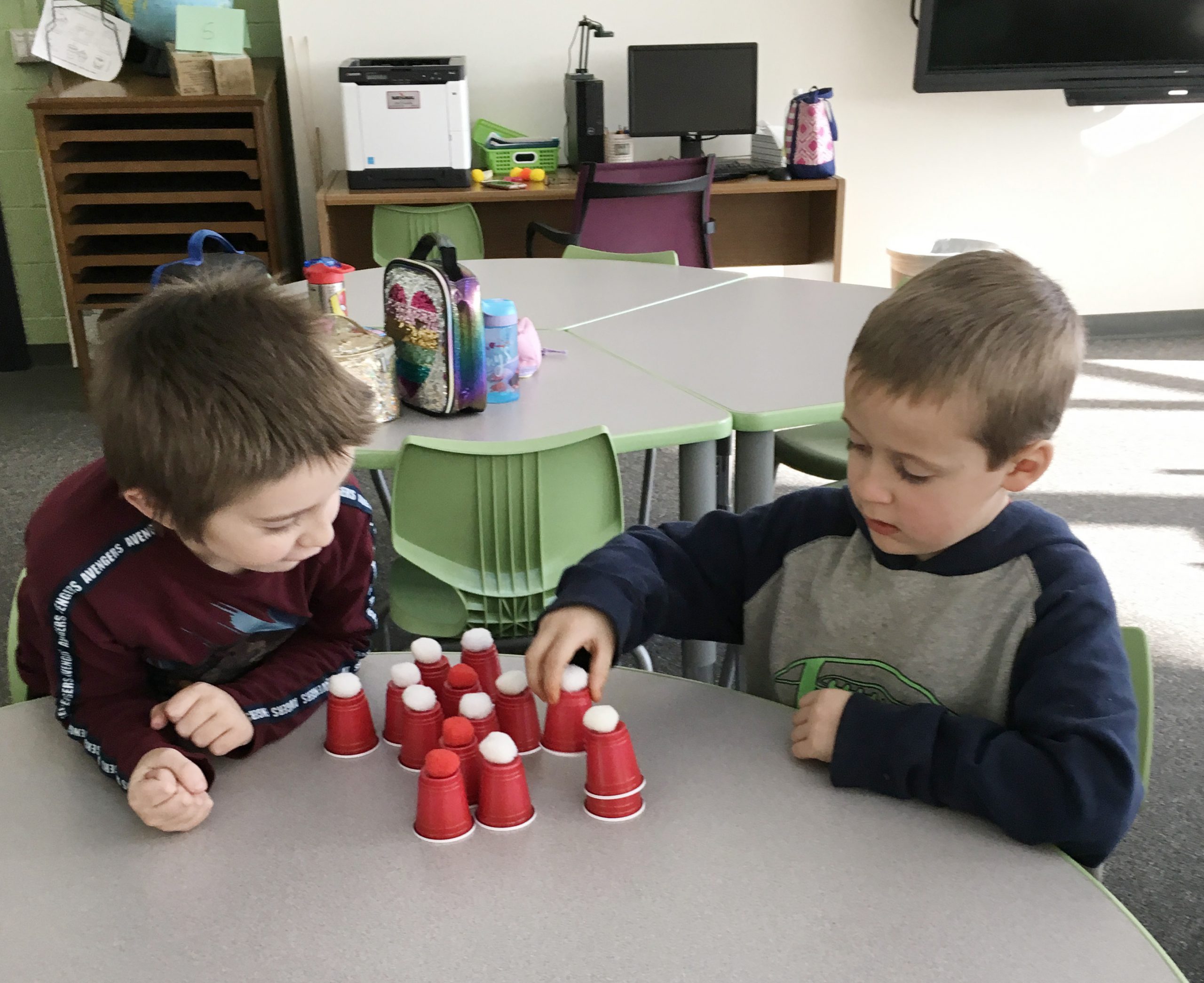 two boys doing holiday craft together