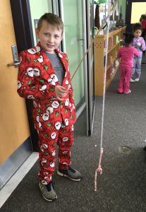 boy wearing pajamas with fake fishing pole