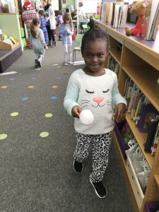 girl dressed in pajamas carrying large snowball