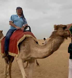 person riding a camel in the desert