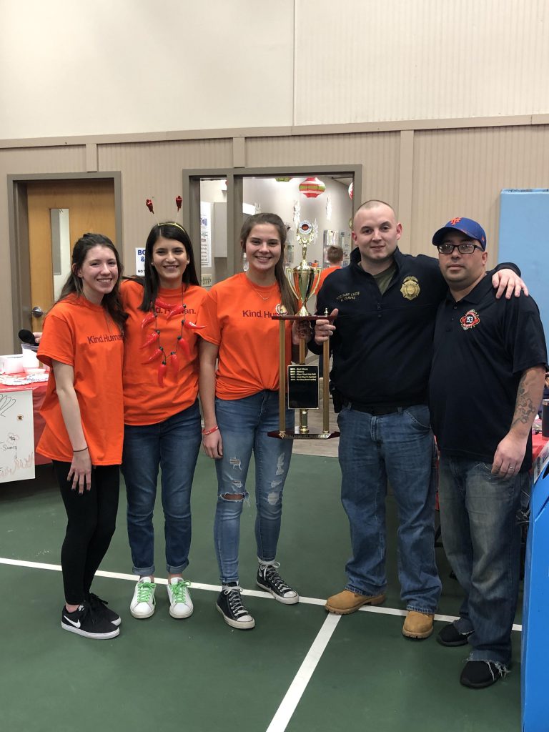 group of students with two represenatives from the Albany Firehouse