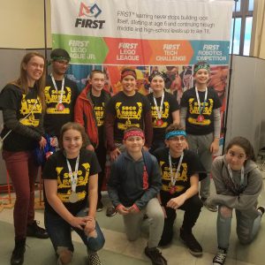 students pose for picture at robotics competition