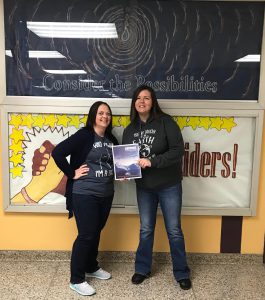 two teachers posing with their published article