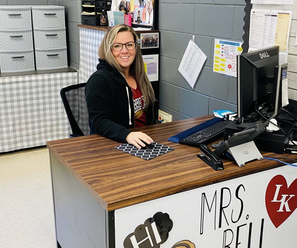 teacher sitting at her desk