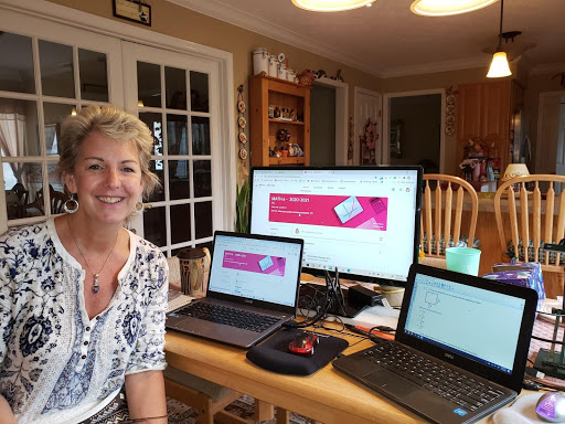 virtual teacher showing off her virtual learning environment at home