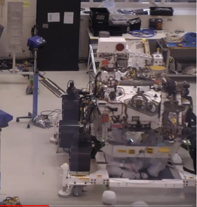 Mr. O'Brien sitting underneath the rover installing new parts.