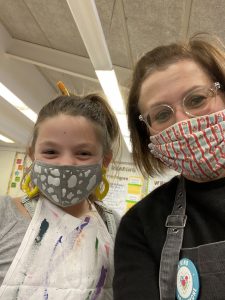 Veeder Elementary Art Teacher Mrs. Ryan and a student in class.