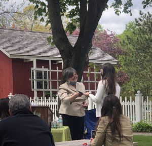 student accepts an award during an outdoor ceremony