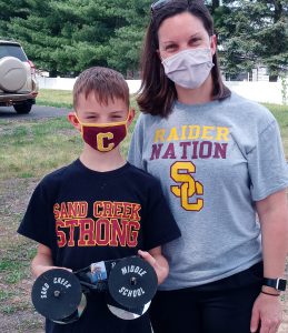 mom and son standing together outside. Each are decked out in Colonie gear!