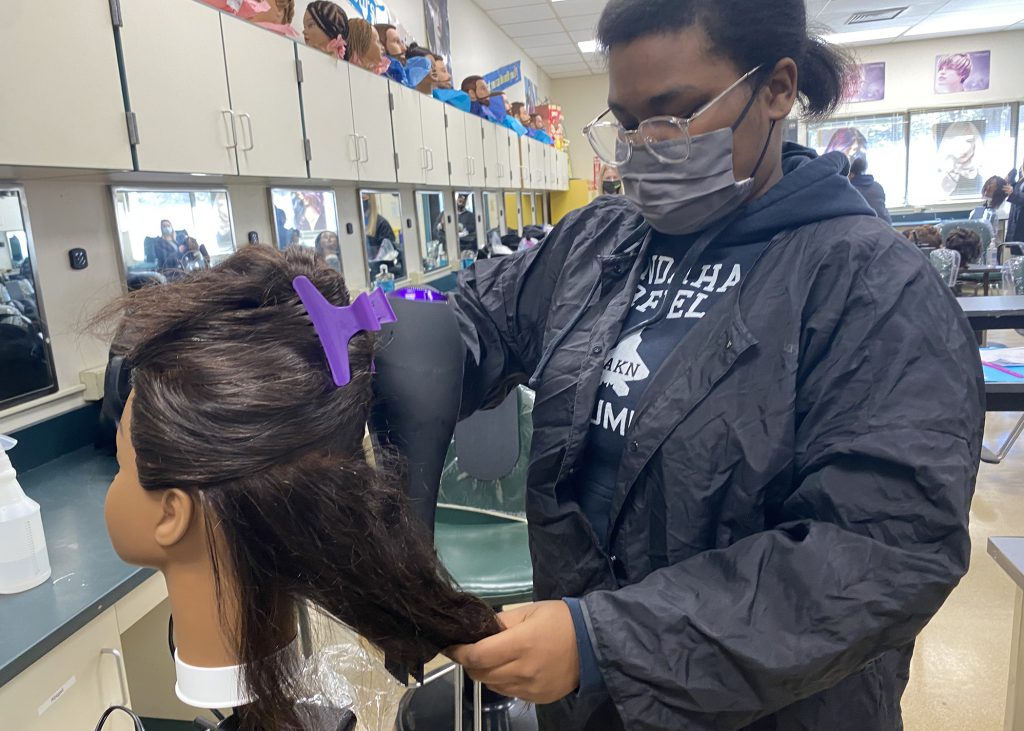 Lashawn Ogilvie blow-drys a mannequin in one of three cosmetology labs on the Albany Career and Technical School Campus.