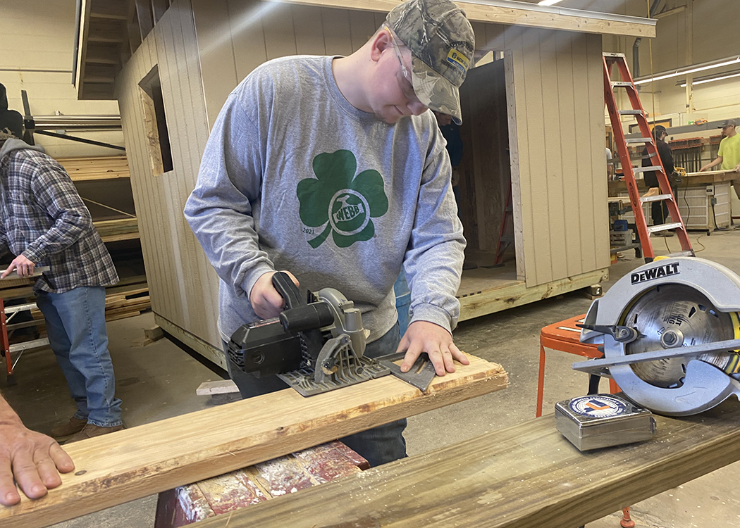 Student uses woodworking tools