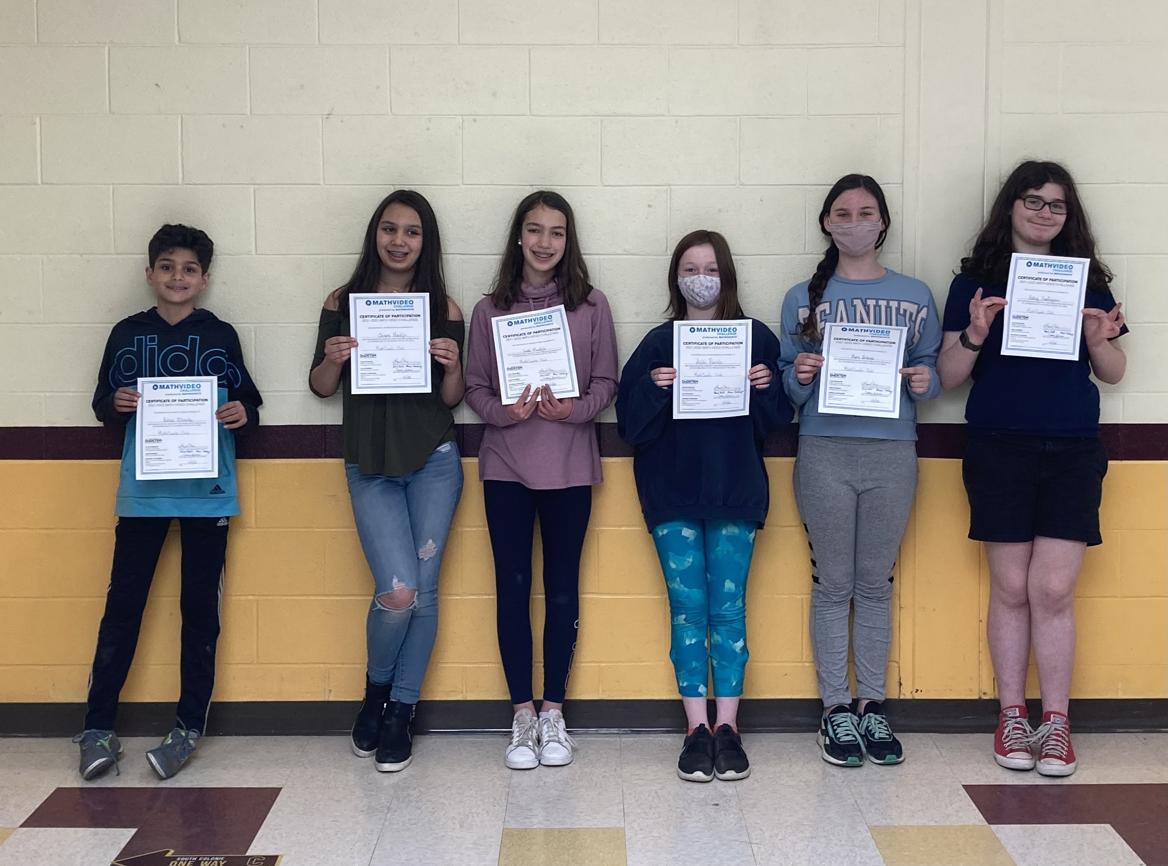 students posing for a photo with their certificates