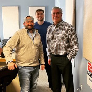 Grady photographed with Rodger Wyland and Eric Hannmann at the 104.5FM ESPN Radio studios.