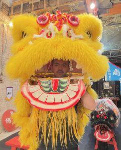 Mr. Ng in the traditional Chinese Lion Dance team costume.