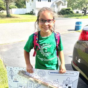 Student smiles with their project