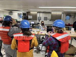 Students watch the researchers at work