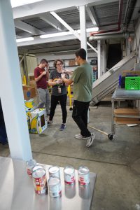 teacher works with students at the food bank sorting food