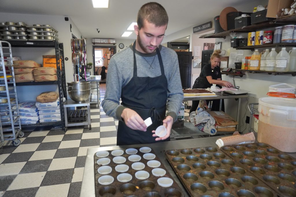 student lines cupcake pans with papers