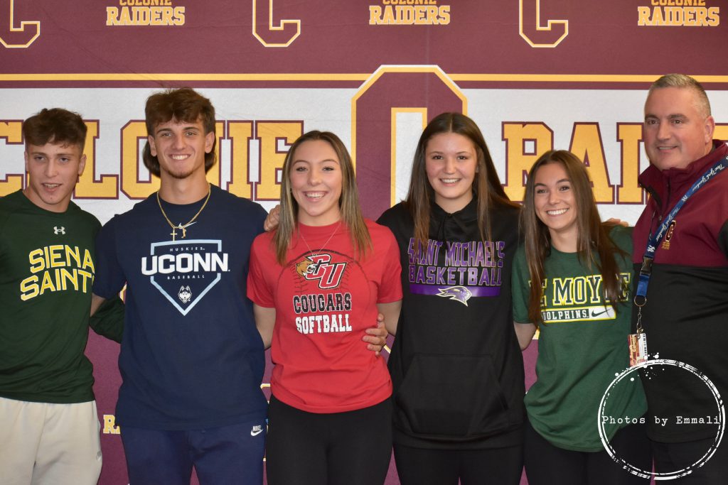 Five athletes smile for a picture