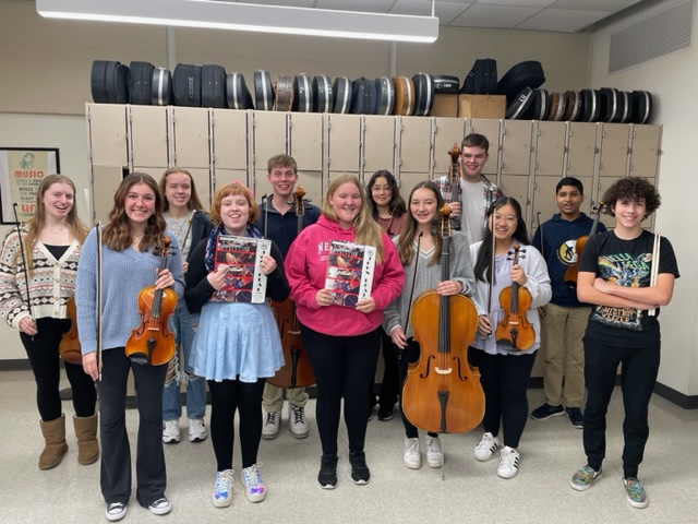 students standing together holding their instruments for a photo