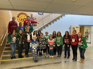 Staff member in ugly sweaters