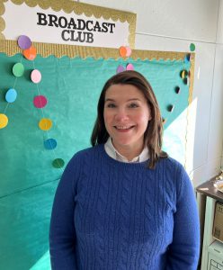 Teacher with short brown hair smiling 