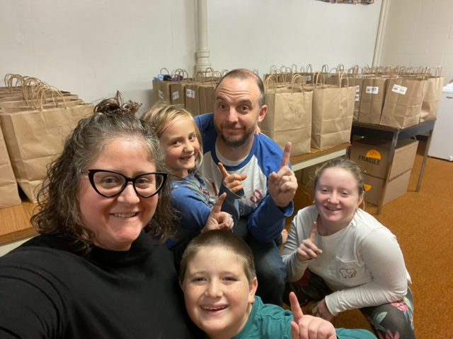 Jessica Lafex and family with bags for the weekend backpack program