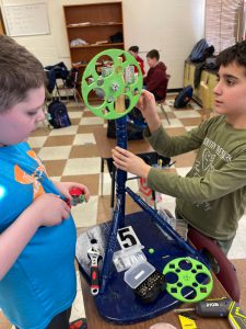 two student work with a gear in the classroom 