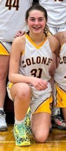 girl in basketball uniform kneeling on court