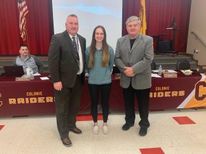 CCHS student poses with Superintendent and BOE president at board meeting.