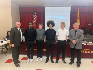 track team posing with Superintendent and BOE President