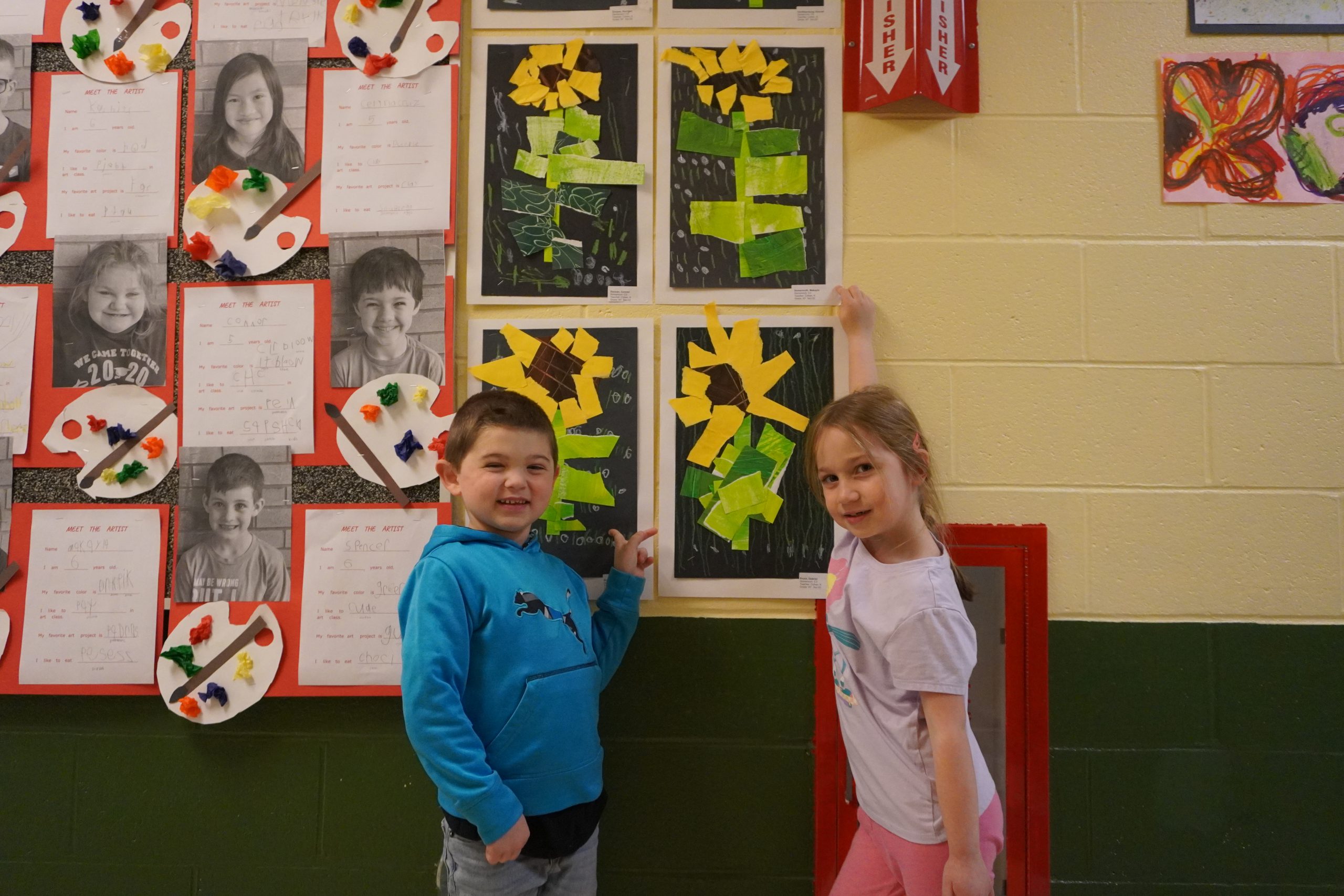 Students point to collages of sunflowers