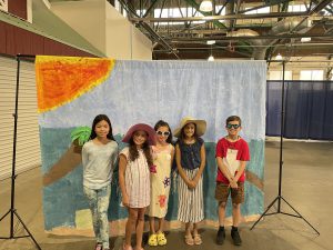 students dressed in costume in front of a set.