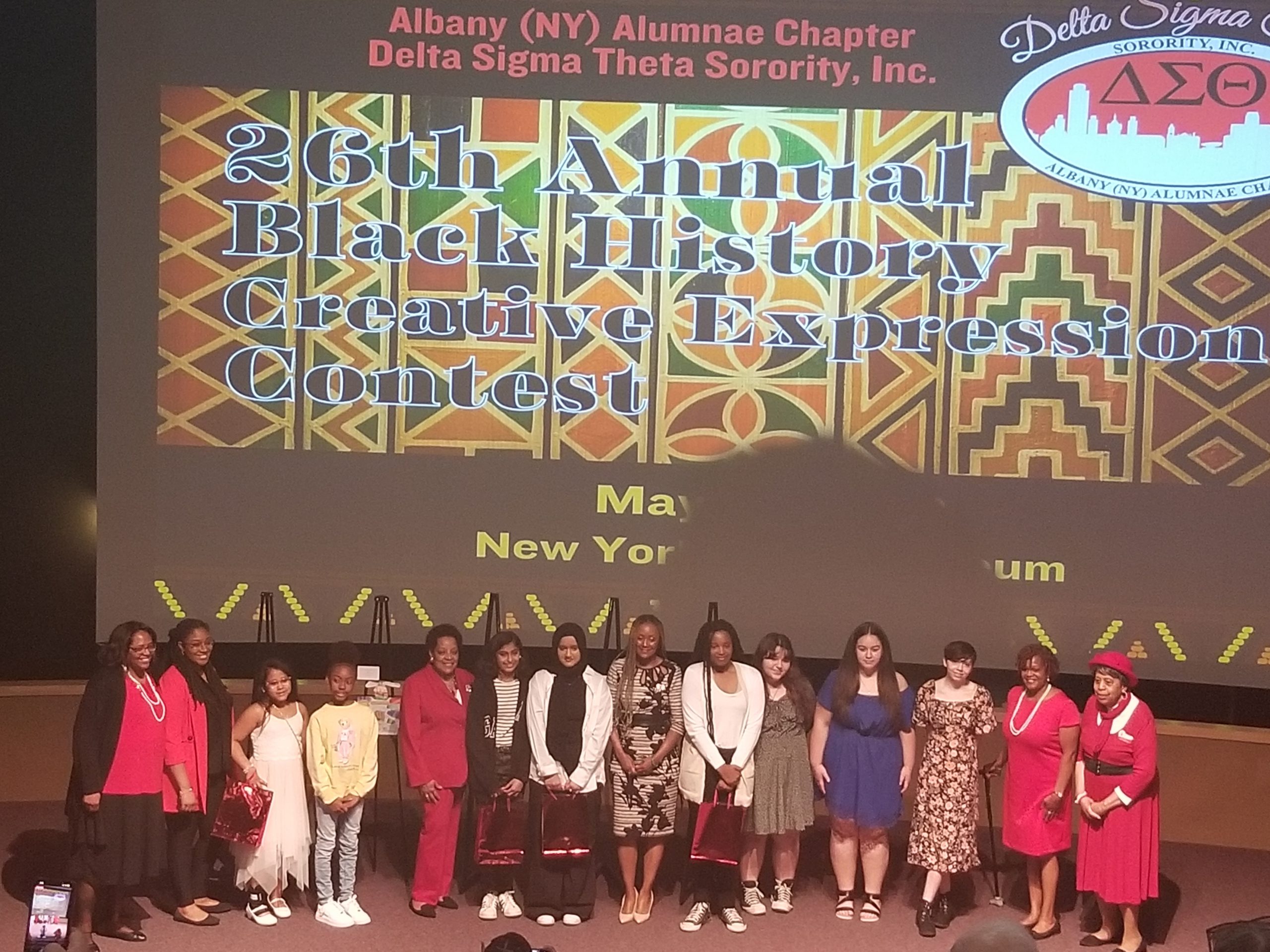 Winners of the 26th Annual Black History Creative Expressions Contest stand together on stage