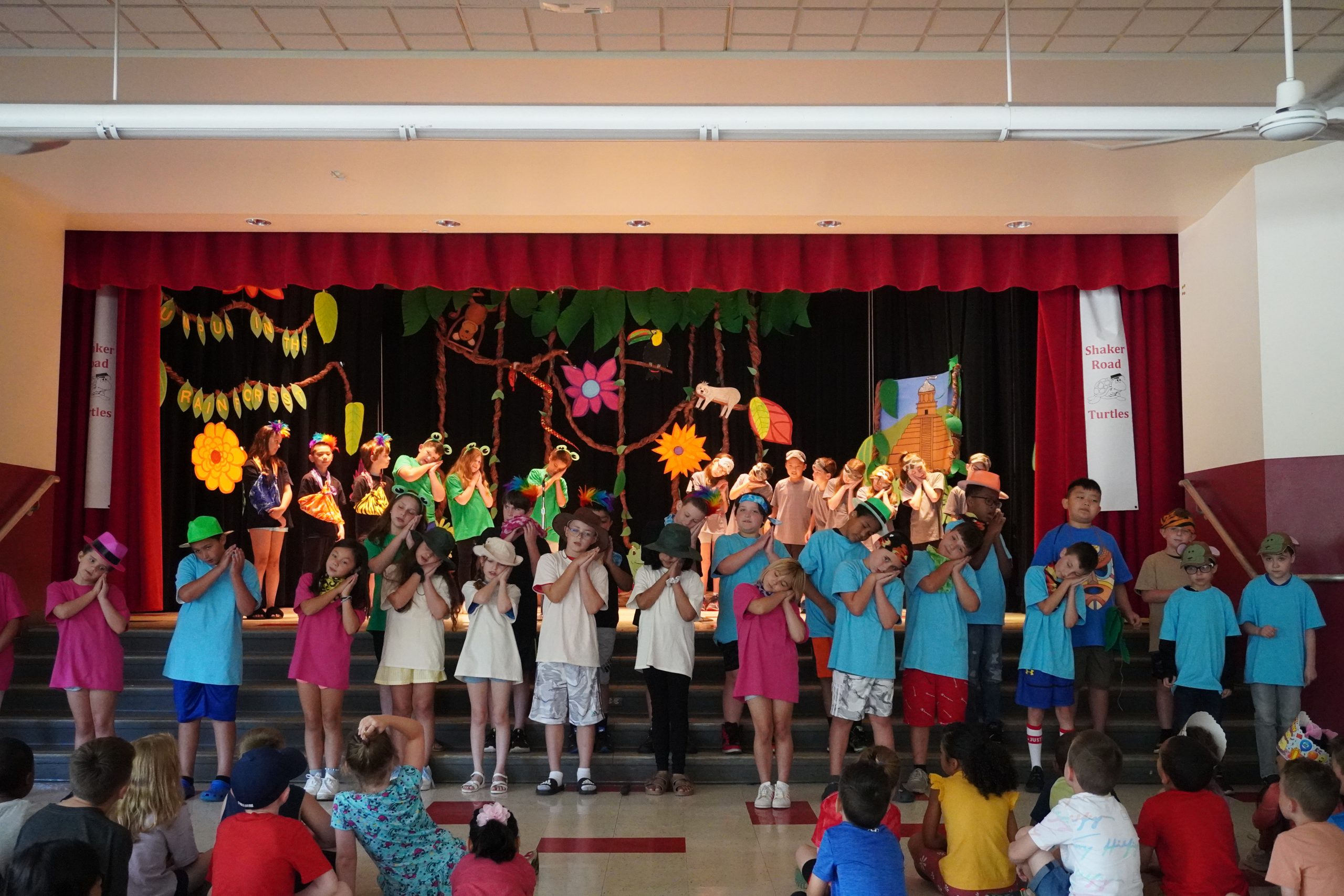 Shaker Road 3rd graders perform songs and choreography on stage