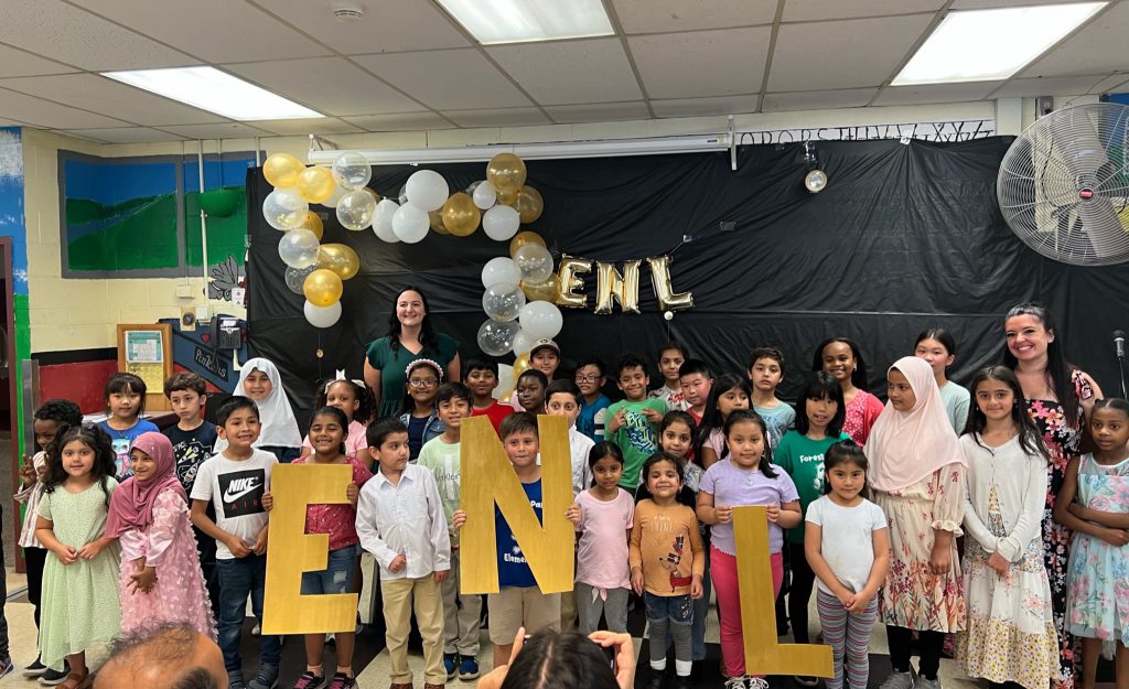 ENL students posing holding giant letters of ENL