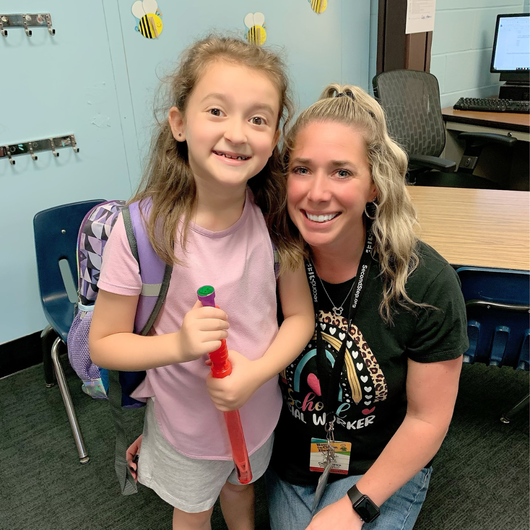 Allison Mullen smiles with a student