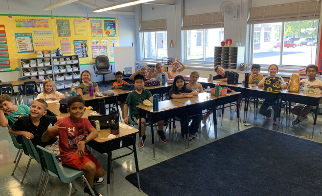 Entire class poses for a photo on the first day of school.