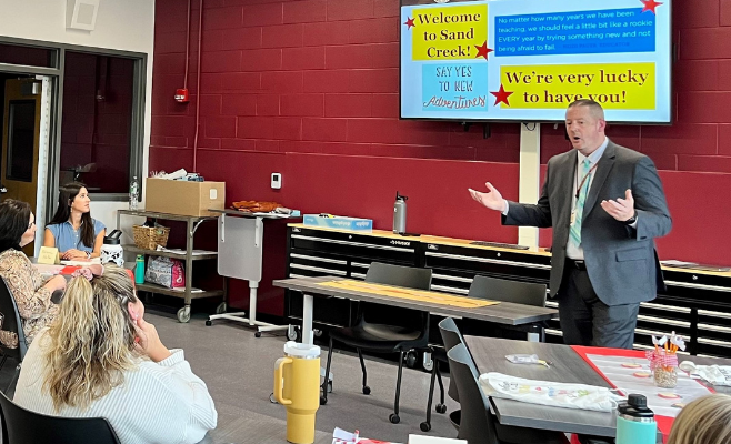 Principal talks to teachers at staff orientation