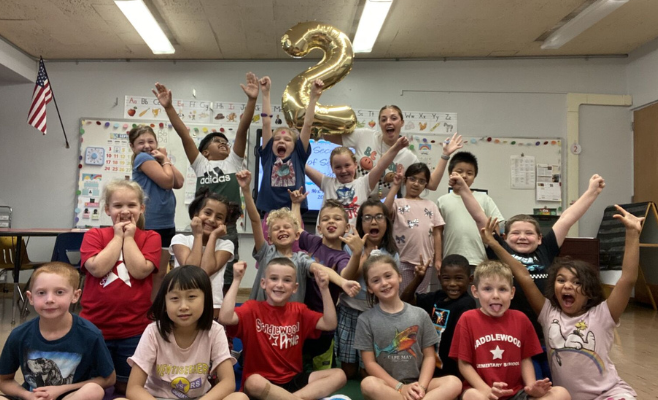 second grade students pose for a photo with a giant 2