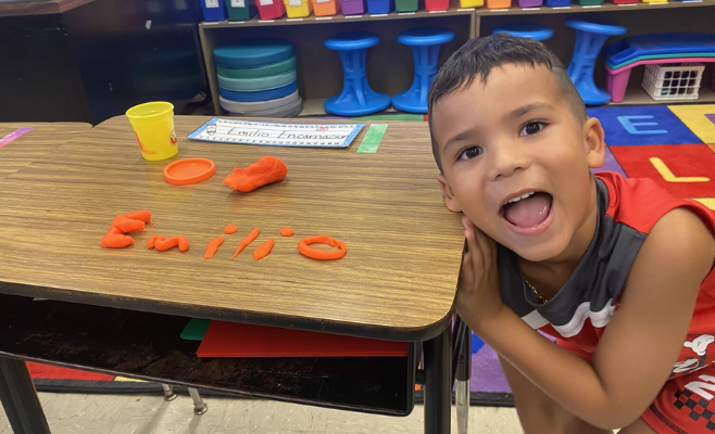 Student spelling out his name with play-doh