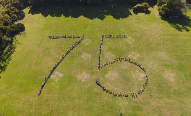 Shaker Road students come together to create a giant 75 in honor of the district's 75 year anniversary