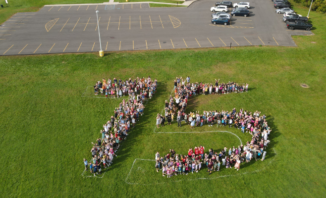 The entire Veeder student body assembled to create a giant 75 in honor of the district's 75th anniversary.