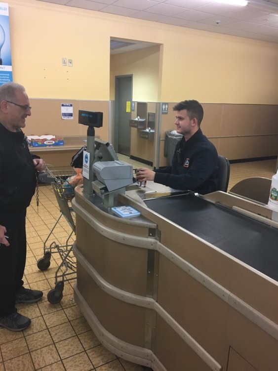 High School Student helping a customer