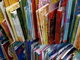 Children's books on library shelves.